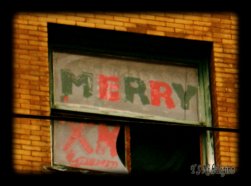 A photograph taken by TS Ni hUiggin of 'Merry X' on a broken window on East Hastings, Van BC.