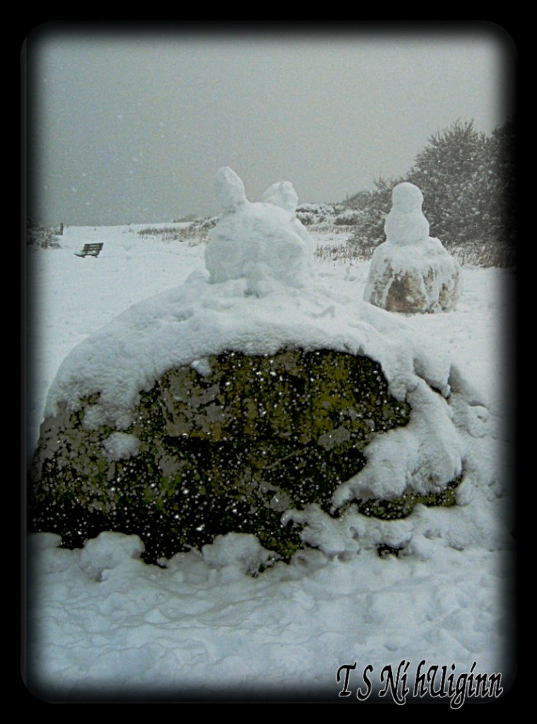 A photo of a snow bunny with a snow man in the background, taken by Salish photographer TS Ni hUiginn